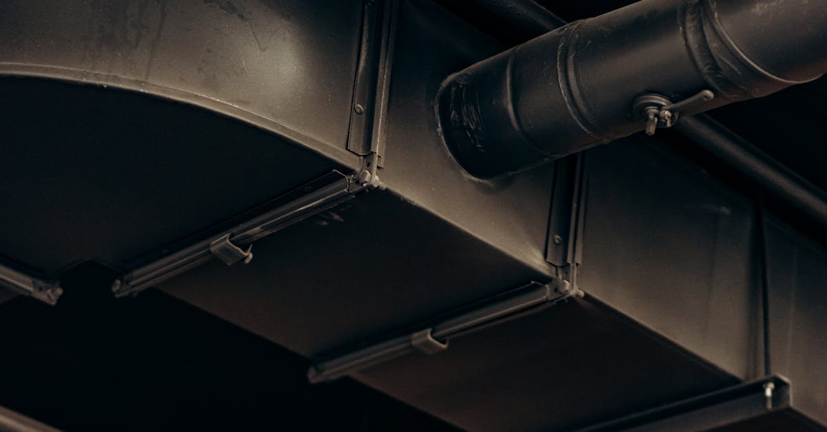 Detailed view of industrial air ducts on a ceiling, showcasing modern urban design.
